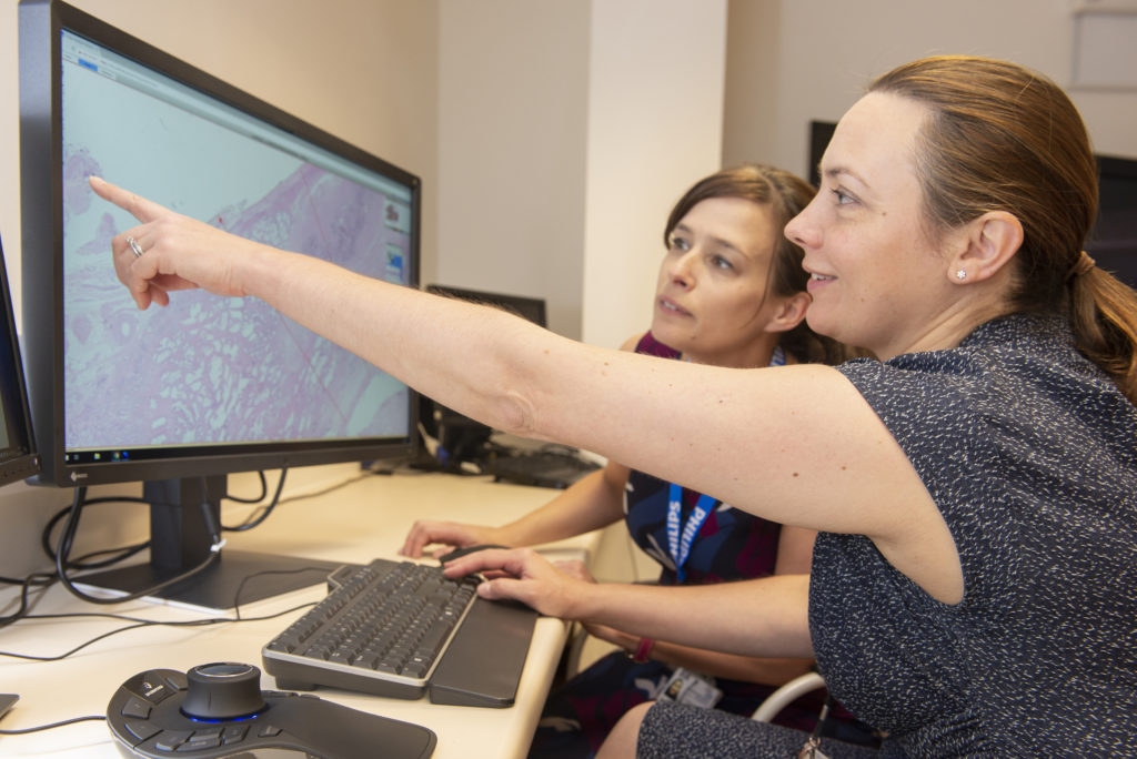 Pathologists Professor Clare Verrill (left) and Dr Lisa Browning look at digital pathology images.