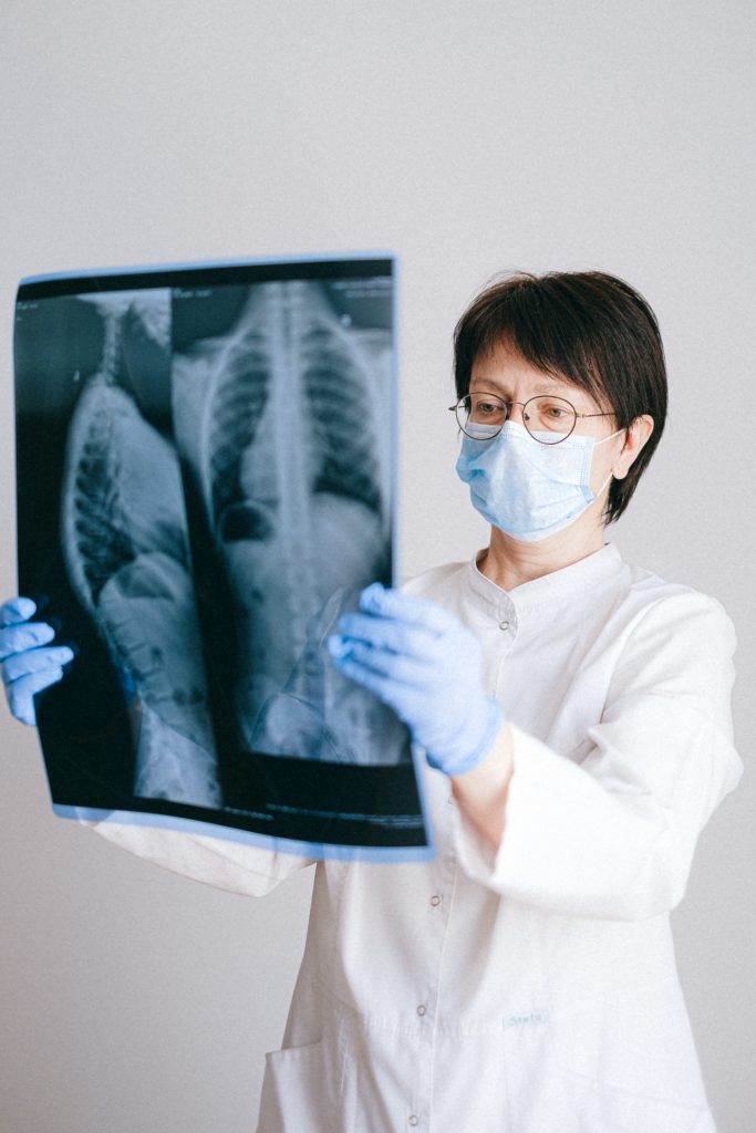 A healthcare professional examines an X-ray. 