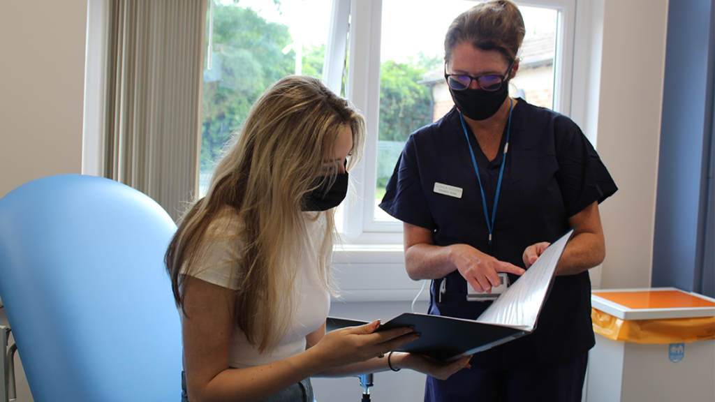 A research nurse and participant in a trial at the Oxford EMCRF