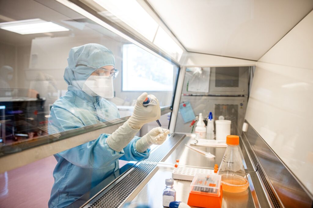 Researcher working in the Oxford Clinical Biomanufacturing Facility