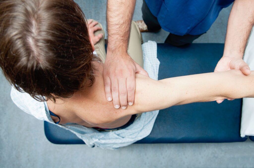 person having their shoulder examined  