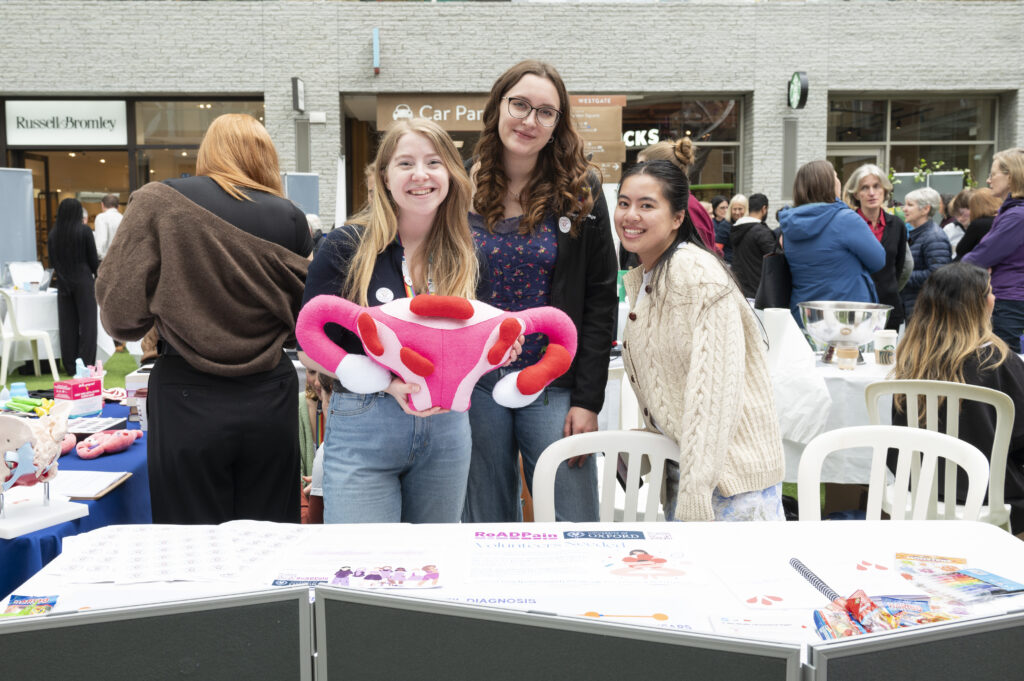 Smiling researchers on the women's health stand.