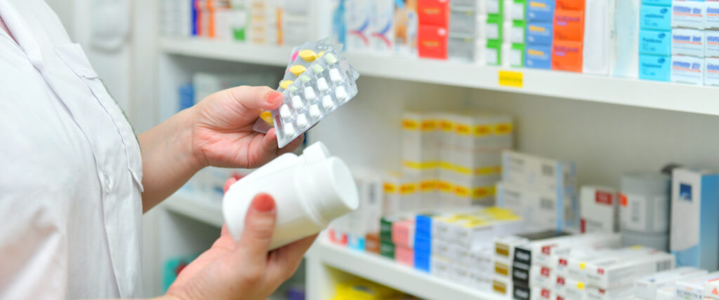 Pharmacist holding a selection of medicines