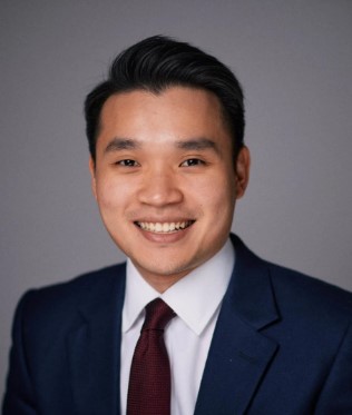 En Lin Goh - young man with short dark hair, wearing jacket and tie