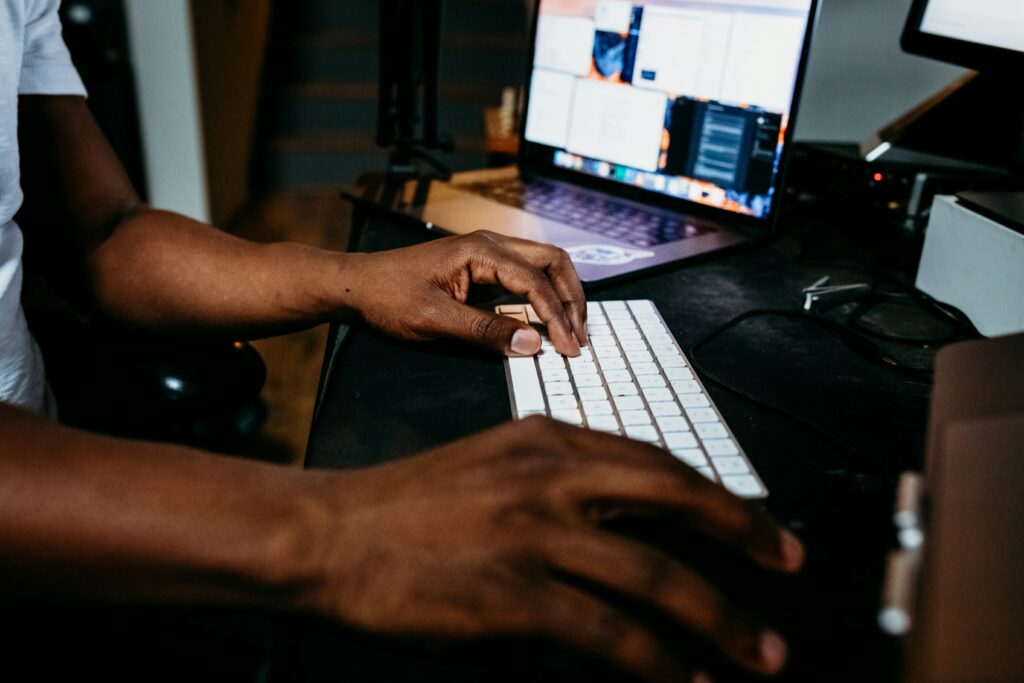 person's hands using a computer keyboard